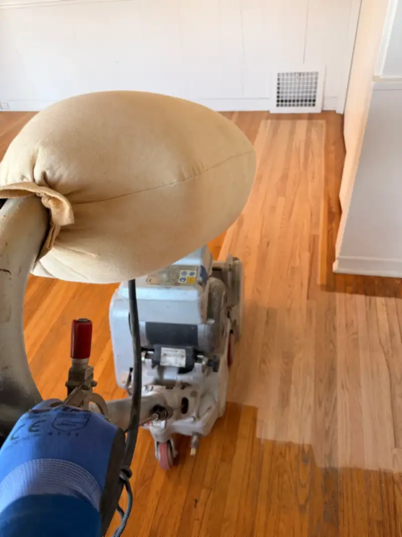 Monteros sanding an oak floor